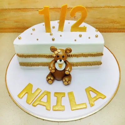 Half birthday cake with teddy bear